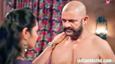 Indian brunette MILF caresses bald muscular man's bare chest passionately in bedroom