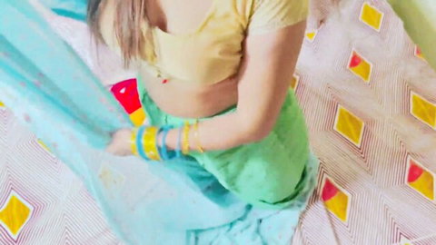 Mahi in low-cut yellow blouse, green skirt, blue dupatta showing cleavage