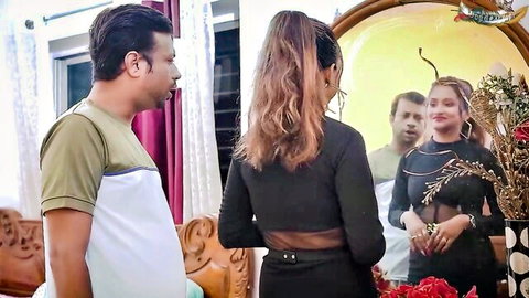 Sexy South Asian woman in sheer black backless dress admired by two men in bedroom mirror reflection