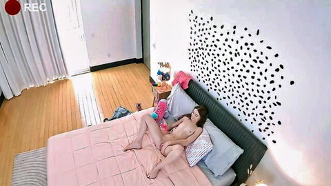 Nude woman spreads legs wide fingering shaved pussy with pink toy on bed