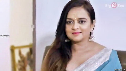 Seductive Indian MILF in blue saree smiling with deep cleavage exposing huge tits
