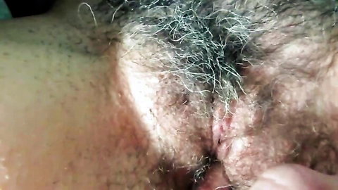 Amateur close-up of wife's hairy pussy being fingered while husband watches