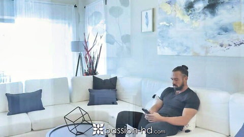 Muscular tanned man with man bun and beard lounging on couch in Passion HD stepdad surprise video