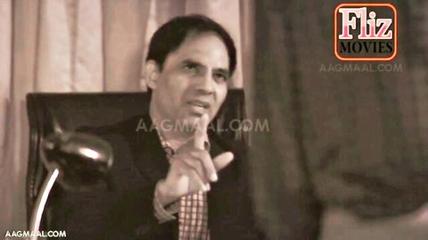 Indian man in suit gesturing passionately in erotic office episode