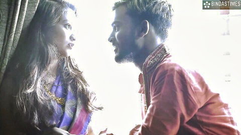 Desi aunty in purple saree shares intimate gaze with man in red kurta