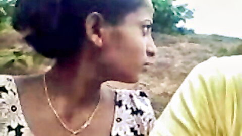 Ebony girlfriend with big tits cleavage in yellow top profile view outdoors with partner
