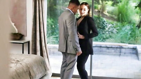 Melissa Stratton in tight business suit embraces suited boss in hotel room