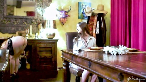 Hazel Moore nude on all fours as Alison Rey sits clothed at table