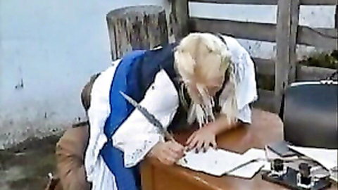 Blonde Anita Paris in white dress bending over farm desk