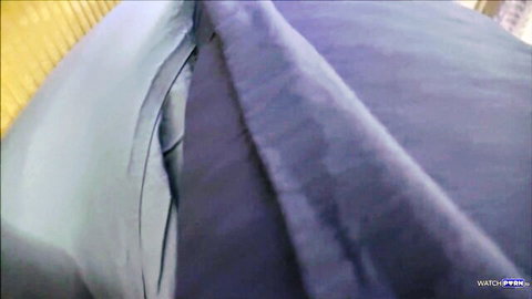 Blurry closeup of rumpled purple bedsheets and pillows on empty bed
