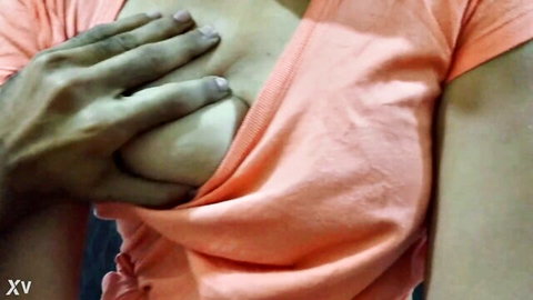 Dark hand groping and exposing curvy South Asian woman's big bare tits from pink tank top