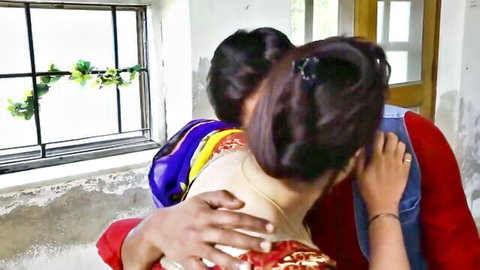 Desi MILF in colorful saree embraced from behind by man in village scene