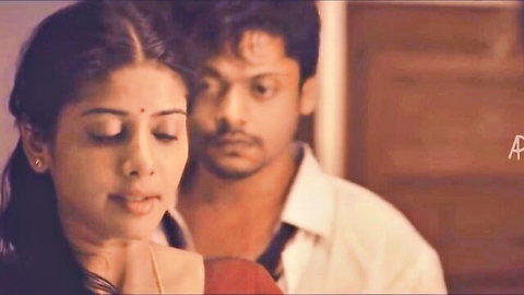 Intimate close-up of Tamil beauty in red saree with handsome man gazing passionately