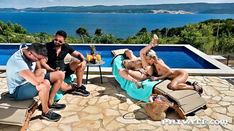 Blonde babe rides cock on pool lounger as two guys watch outdoors by ocean.