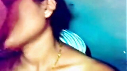 Indian girl with dark hair, gold necklace and neck tattoo in intimate profile view