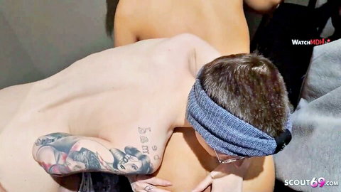 Tattooed muscular men nude from behind in threesome pile with blue headband
