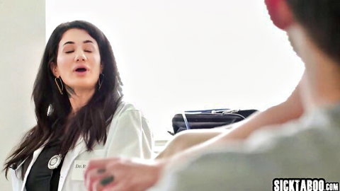 Vanessa Vega as seductive doctor in white coat with patient