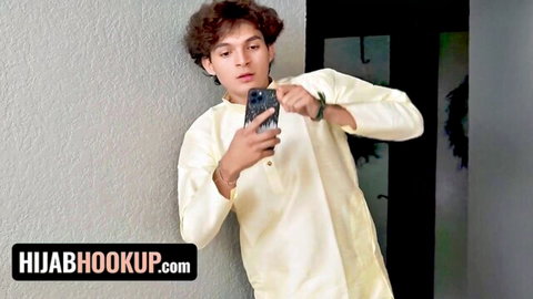 Handsome Arab guy in yellow kurta takes selfie for hijabhookup site