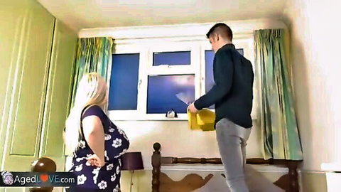 Curvy blonde BBW in floral dress showing big ass standing by window with man holding package