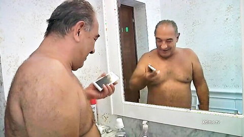 Middle-aged hairy man shirtless mirror selfie in bathroom, amateur solo