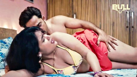 Indian MILF in yellow bikini passionately embraces shirtless lover in bed