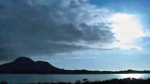 Dramatic sunset over lake with mountains in softcore Japanese teen scene