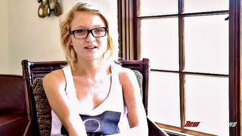 Dakota Skye blonde with glasses in white tank top smiling seductively