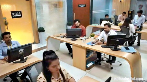 Indian office workers in casual attire at desks, boss door visible