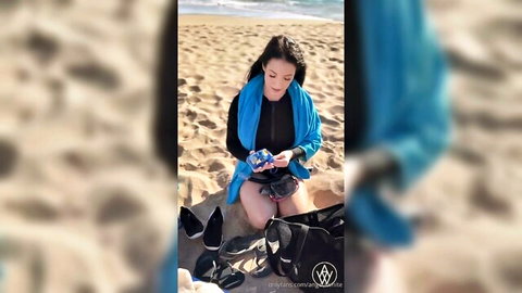 Angela White kneeling sexy on beach in blue shawl and skirt