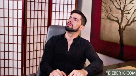 Bearded Julian Brady in black shirt, intense gaze in office interview