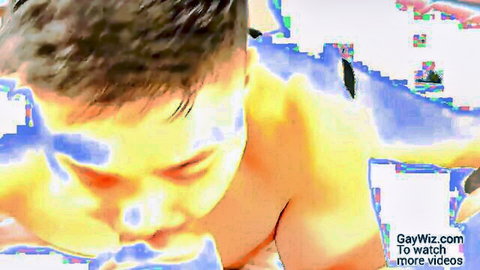 Closeup of hot East Asian gay man's intense face and bare chest during steamy action