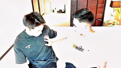 Two Asian muscular guys in t-shirts playfully grabbing arms after gym session