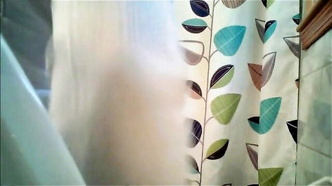 Blonde babe teasing behind steamy patterned shower curtain