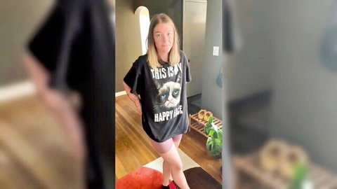 LakinDayXO in oversized Grumpy Cat tee and pink shorts, teasing pose