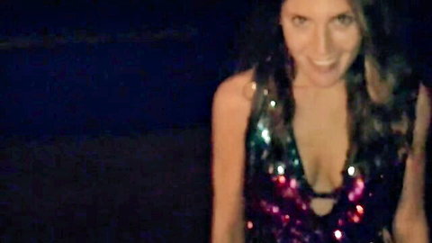 Curvy smiling Latina in sparkly deep V-neck dress showing huge cleavage tits