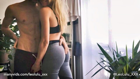 Muscular shirtless guy gropes fit blonde's exposed ass cheeks from behind with gray leggings pulled down