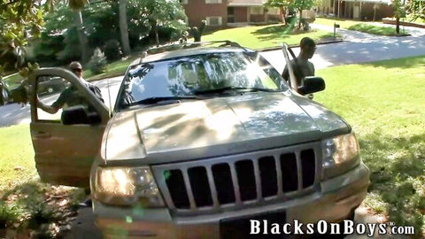Muscular black stud pulls out huge BBC for white twink blowjob by open Jeep door