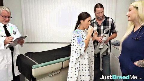 Brunette patient in polka-dot gown with doctor, blonde nurse, and bearded cuckold husband in hospital exam room