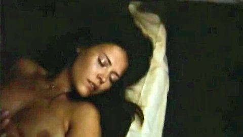 Vintage German nude brunette lying topless in bed from steamy group sex scene