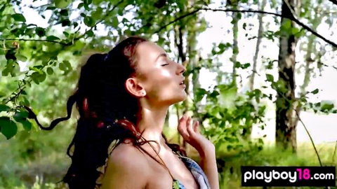 Gloria Sol in colorful bikini posing sensually outdoors in forest