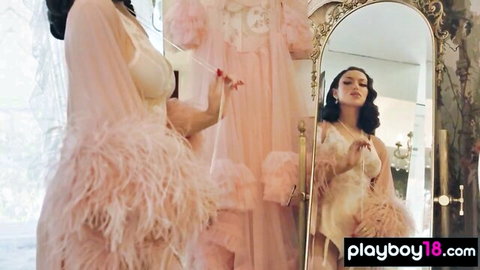 Busty brunette Bryona Ashly teases massive knockers in pink feathered lingerie