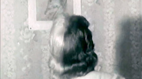 Vintage 1940s black and white stripper woman slipping dress from behind