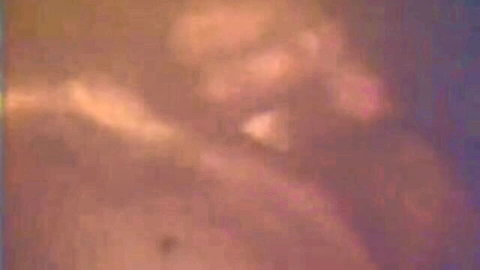 Blurry orange-tinted closeup of nude skin and pussy lips in retro style