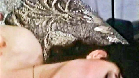 Vintage blonde woman passionately kissed on neck by man in steamy retro lingerie close-up