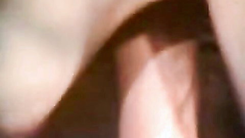 Blurry close-up of fair-skinned woman's large heaving tits and deep cleavage in sensual tease