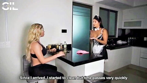Sexy brunette maid in skimpy outfit cleans kitchen counter as blonde babe in bra watches her curves