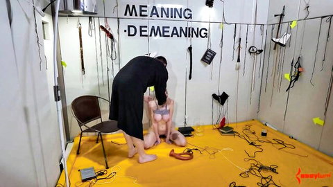 Skinny nude babe kneels legs spread shaved pussy exposed as man yanks her head back in BDSM domination