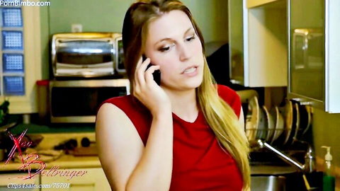 Xev Bellringer as sexy MILF mom on phone in red tank top