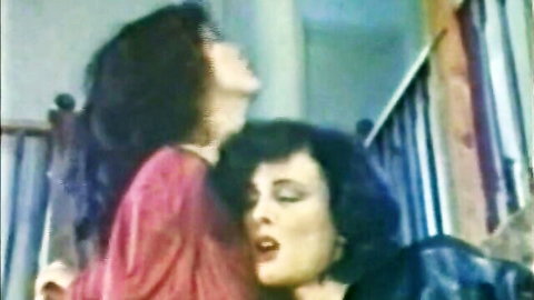 Laurie Smith and Jacqueline Brooks in intense lesbian embrace and kiss