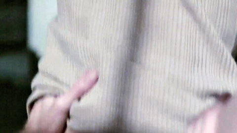 Man's hand with extended pointing finger from beige striped shirt sleeve closeup